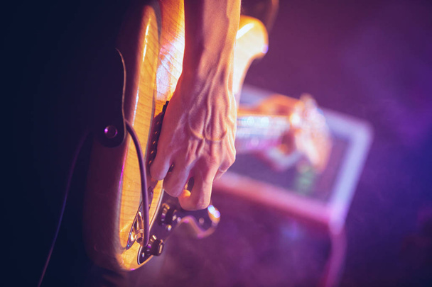 Guitarist playing solo part on concert with bass guitar - 写真・画像