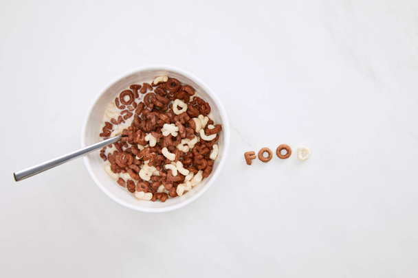 top view of cereal food inscription near bowl on marble surface - Foto, Bild