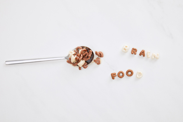 top view of cereal brain food inscription near spoon on marble surface - Photo, Image