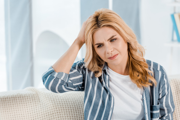 tired woman touching head and having headache at home  - Photo, Image