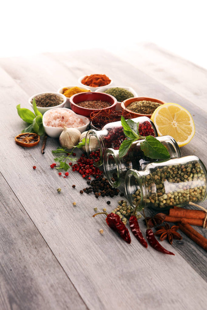 Spices and herbs on table. Food and cuisine ingredients with bas - Photo, Image