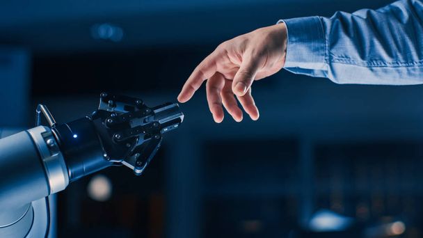 Futuristic Robot Arm Touches Human Hand in Humanity and Artificial Intelligence Unifying Gesture. Conscious Technology Meets Humanity. Concept Inspired by Michelangelo's Creation of Adam - Foto, Imagem