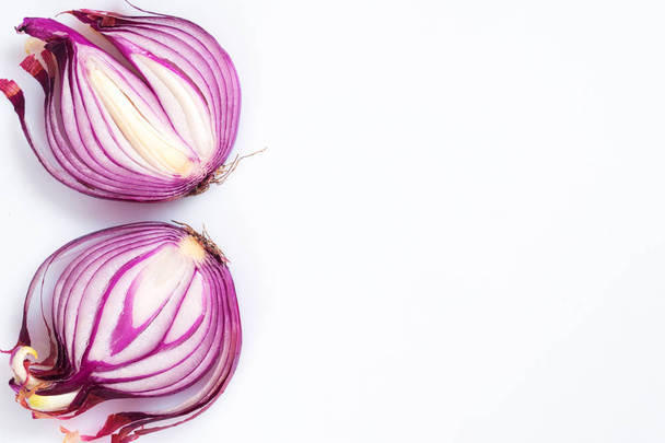Red onion cut in half on a white background - Fotó, kép