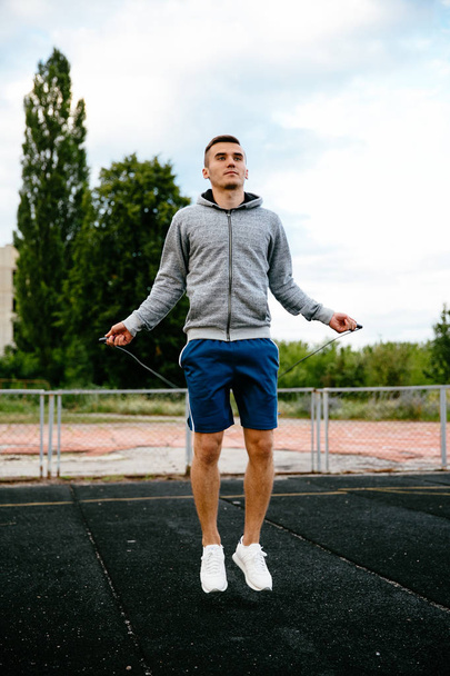 Jumping guy with skipping rope - Foto, Bild