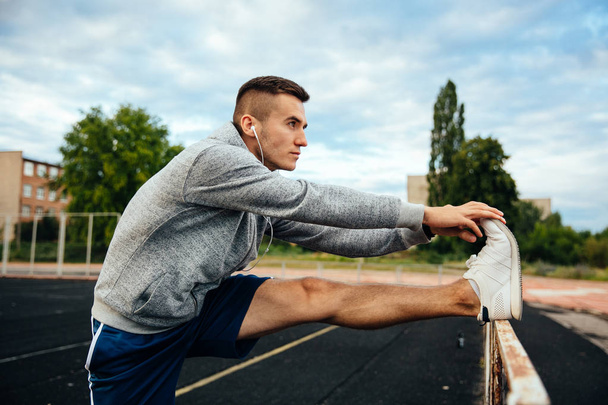 Profile view of a man doing exercises - 写真・画像