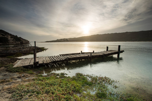 Wide angle landscape image of an old jetty on an estuary. - Photo, Image
