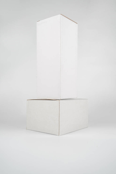 White two paper boxes - tall and fat lay on the white background - Photo, Image