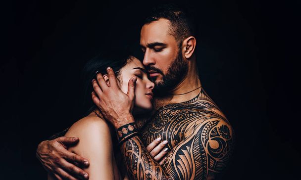 Man hugging woman with love. Sensual couple in love. Erotic love of hispanic man and sexy woman - Фото, изображение