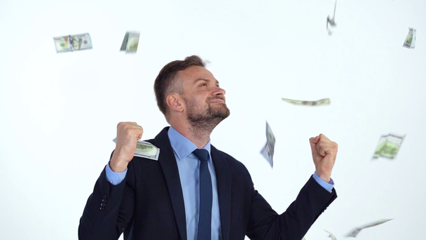 Slow motion of formally dressed man is delighted with the fact that a lot of dollar bills are fall on him - Footage, Video