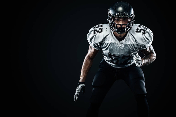 American football sportsman player in helmet on black background. Sport and motivation. Team sports. - Foto, Bild