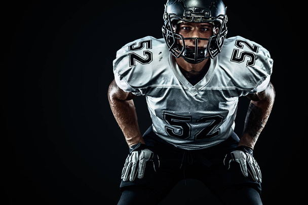 American football sportsman player in helmet on black background. Sport and motivation. Team sports. - Fotoğraf, Görsel