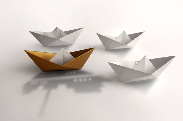 Leadership concept, gold paper boat  - Фото, изображение
