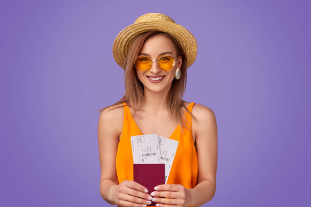 Cheerful tourist with tickets and passport - Zdjęcie, obraz