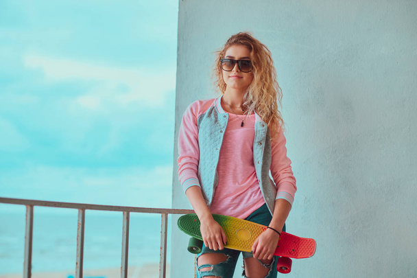 Attractive skatebordist is posing for photographer - Photo, Image