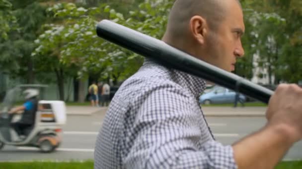 Εγκληματίας που περπατάει στην πόλη με ρόπαλο του μπέιζμπολ - Πλάνα, βίντεο