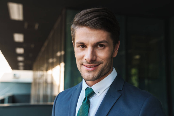 Photo of joyful businessman smiling and standing outside job cen - Fotografie, Obrázek