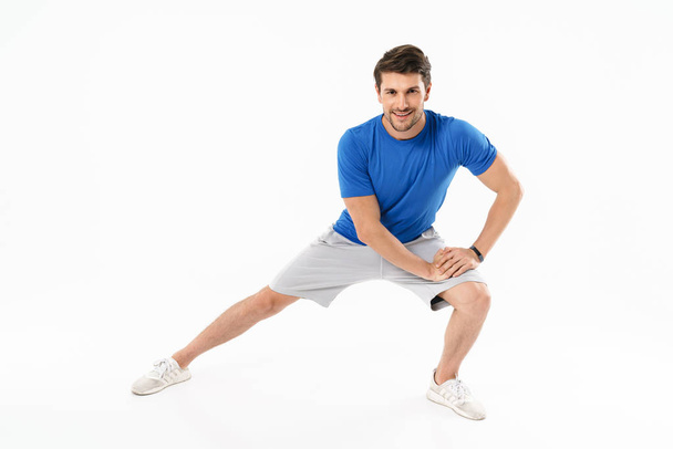 Photo of muscular athletic man in shorts and t-shirt doing sport - Φωτογραφία, εικόνα