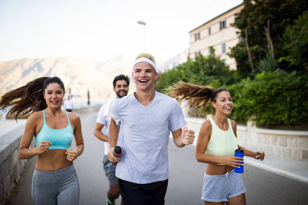 Happy friends fitness training together outdoors living active healthy - Φωτογραφία, εικόνα