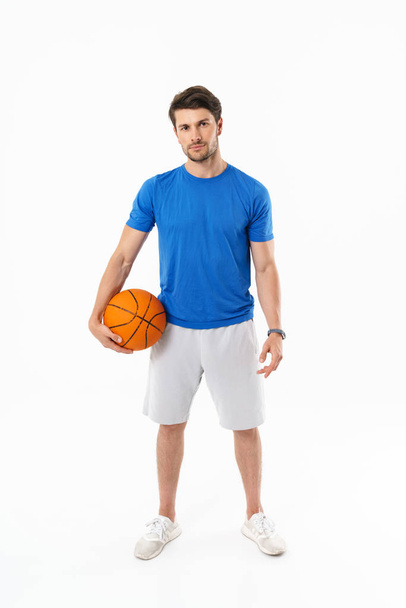 Attractive young fit sportsman wearing t-shirt standing - Foto, Imagem