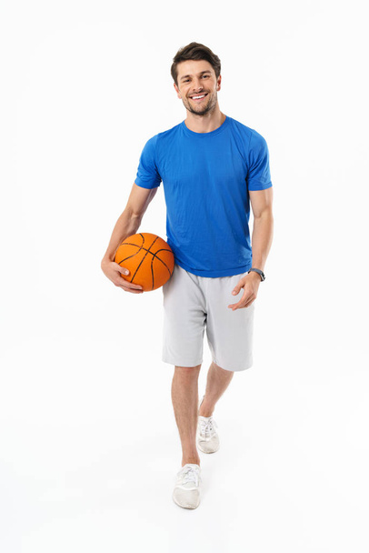 Attractive young fit sportsman wearing t-shirt standing - Foto, immagini