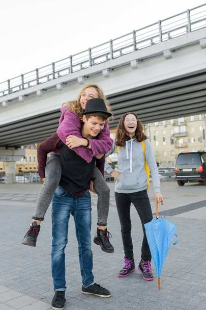 Teens boy and two girls talking and having fun outdoor - Φωτογραφία, εικόνα