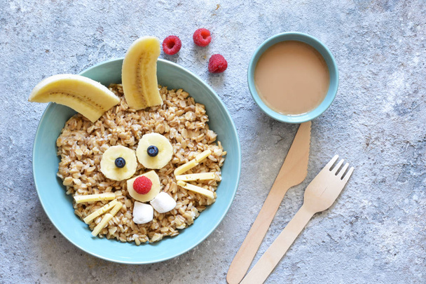 Funny hare - breakfast for the child. Oatmeal with berries and cocoa. - Фото, зображення