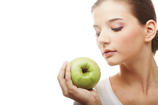 Head shot of woman holding apple - Foto, Imagem