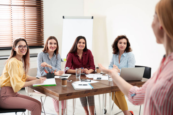 Female professional business trainer working with ladies in office. Women power concept - Photo, image