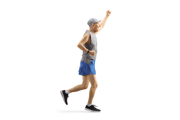 Elderly man in sportswear running and gesturing happiness - Foto, immagini