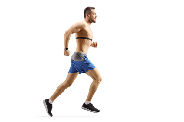 Young man running and wearing a chest strap monitor  - Foto, Imagem