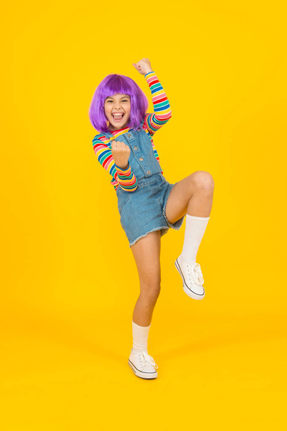 Cosplay character concept. Culture hobby and entertainment. Cosplay outfit. Otaku girl in wig smiling on yellow background. Happy childhood. Anime fan. Cosplay kids party. Child cute cosplayer - Foto, Bild