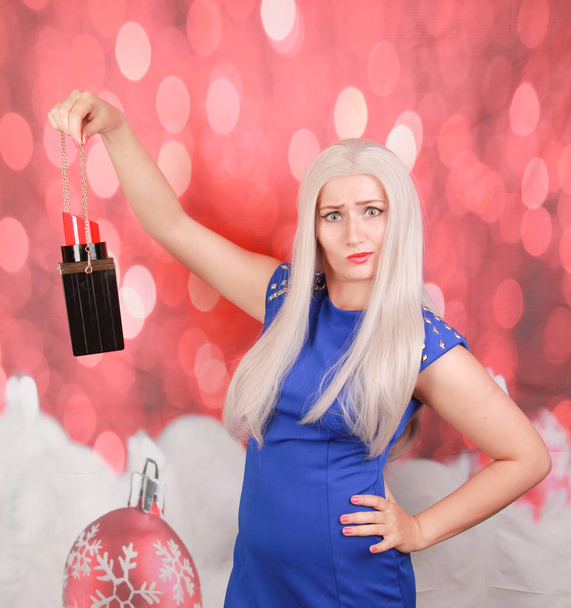 pretty blonde in blue dress with fashionable big lipstick bag - Photo, Image