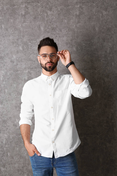 Portrait of handsome man in glasses on grey background - Zdjęcie, obraz