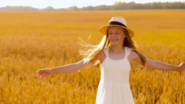 happy girl in straw hat on cereal field in summer - Felvétel, videó
