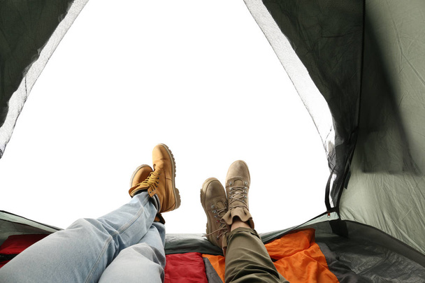Closeup of couple in camping tent on white background, view from inside - Photo, image