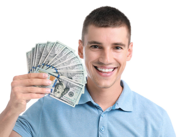 Handsome young man with dollars on white background - Zdjęcie, obraz