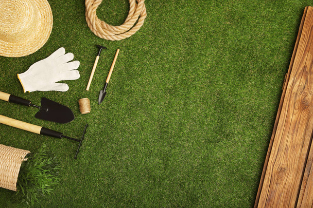 Set of gardening tools on green grass, flat lay. Space for text - Zdjęcie, obraz