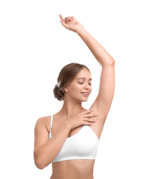 Young woman with smooth clean armpit on white background. Using deodorant - Foto, imagen