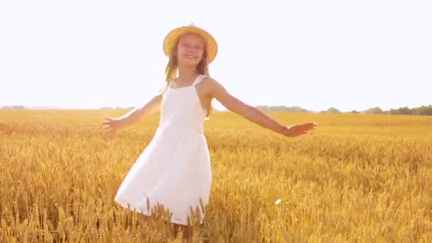 happy girl in straw hat on cereal field in summer - Кадри, відео