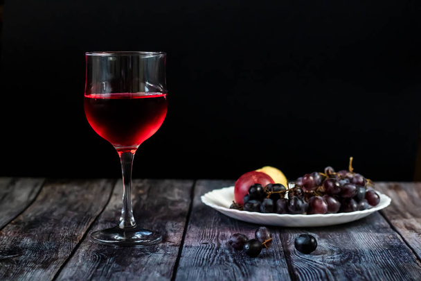 Pink wine. Wine in a glass near fruits and grapes. Traditional Georgian wine according to ancient technology. Copy space Close up and vertical orientation. - Фото, зображення