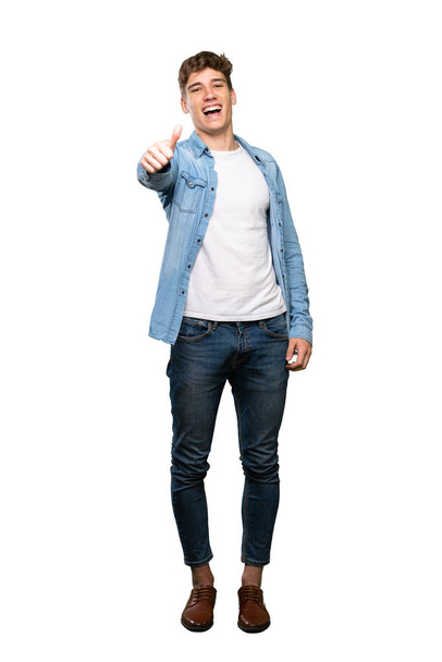 A full-length shot of a Handsome young man with thumbs up because something good has happened over isolated white background - Photo, image