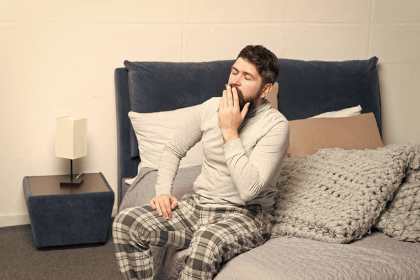 Get up early. Tips for waking up early. Man bearded hipster sleepy face waking up bedroom interior. Schedule for healthy lifestyle. Sweet yawn. Rest and relax. Problem with early morning awakening - Fotoğraf, Görsel