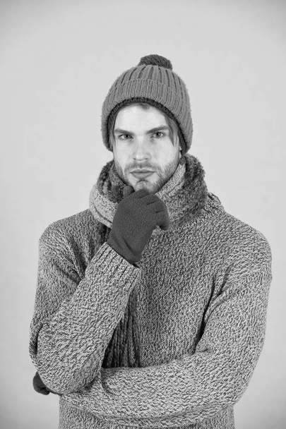 Knitted accessories as hat and scarf. Man in knitted hat and scarf winter fashion season. Man wear knitted clothes turquoise background. Winter accessories concept. Winter fashion knitted clothes - Foto, Imagem