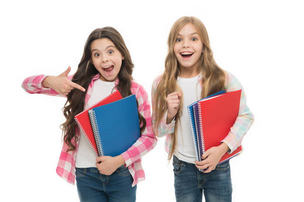 Happy to be students. School supplies concept. We love study. School stationery. Pupils carrying big textbooks to school classes. Taking extra classes. Girls with school textbooks white background - Photo, Image