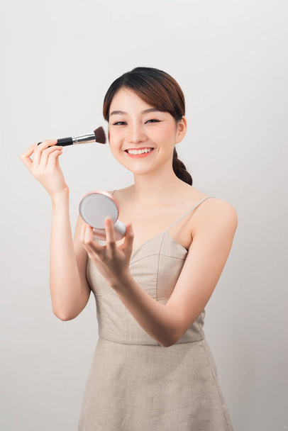 Beauty brunette girl having fun and joking with make up and face powder. - Photo, Image
