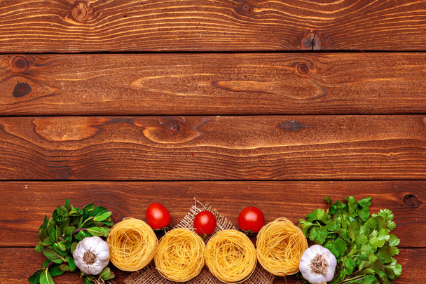 dried pasta on wooden background - Fotó, kép