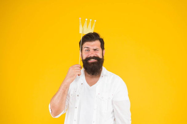Handsome bearded guy king. Guy in yellow background posing with booth props. Photo booth fun. Bearded man king costume party. King of party. Costume party. Holiday carnival celebration. Birthday boy - Fotó, kép