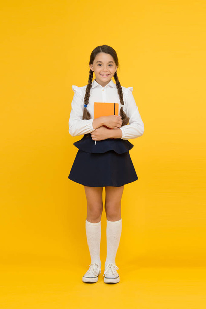 Inspirational quotes motivate kids for academic year ahead. School girl formal uniform hold book. School lesson. Study literature. Towards knowledge. Learn following rules. Welcome back to school - Valokuva, kuva