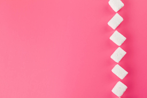 Cubes of sugar on bright pink background - Фото, изображение
