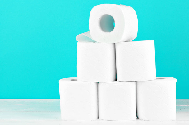 Toilet paper rolls on turquoise bright background - Фото, изображение
